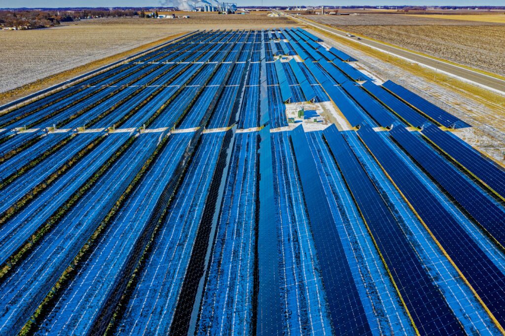 Expansive aerial view of solar panels in Claremont, MN, highlighting renewable energy.